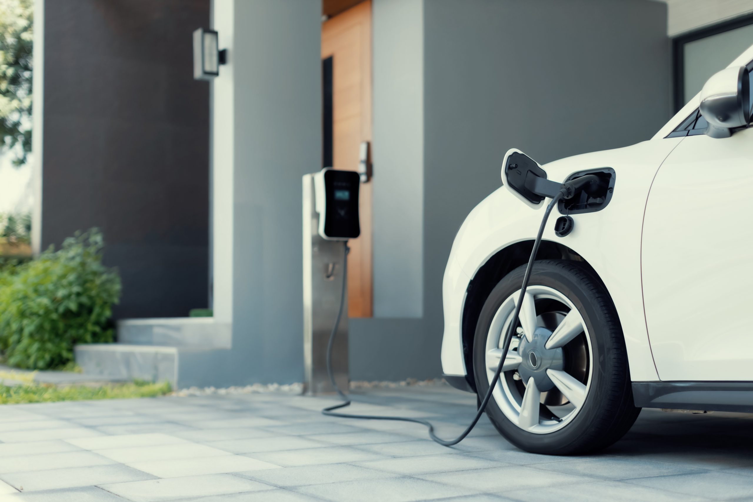 Progresivní koncept nabíjení elektromobilů a domácích nabíjecích stanic poháněných udržitelnou a čistou energií s nulovými emisemi CO2 pro zelené životní prostředí. Nabíjecí bod pro elektromobily v obytné oblasti.